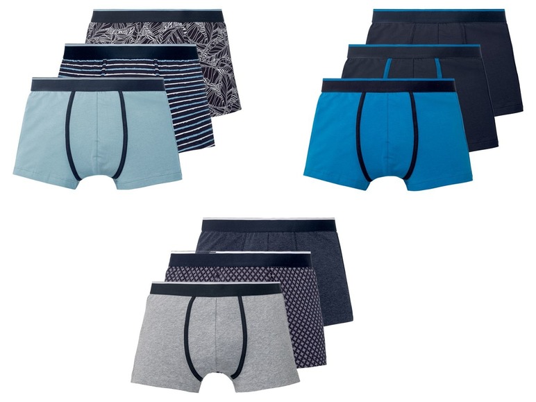 Drie paar boxershorts in verschillende kleuren en patronen.