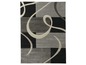 Een grijs en zwart tapijt met een modern, abstract ontwerp.