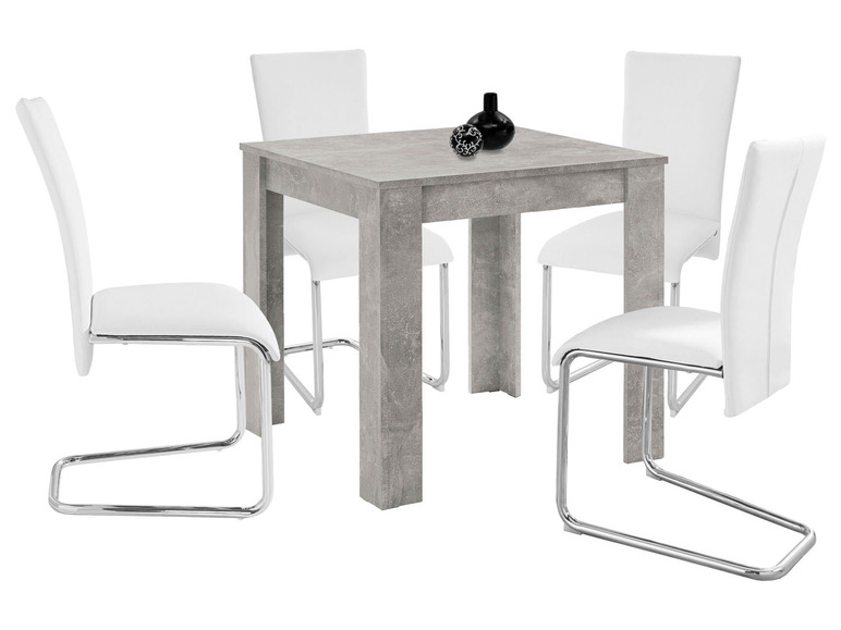 Een eettafelset met vier witte stoelen en een grijze tafelblad.