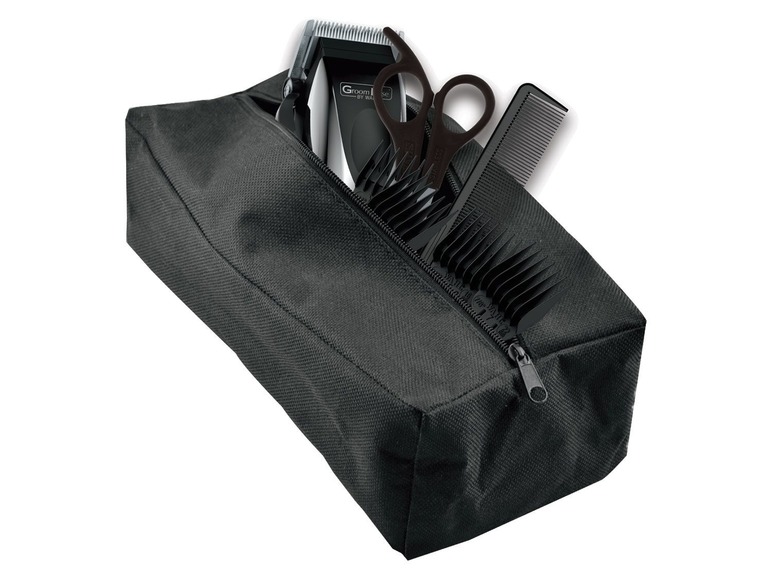 Een zwarte tas met een tondeuse, schaar en kammen.