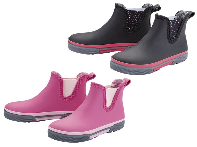 Twee paar regenlaarzen, zwart met stippen en roze.