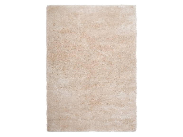 Een beige vloerkleed met een zacht, pluche oppervlak.