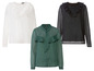 Drie blouses met ruches: wit, zwart met stippen en groen.