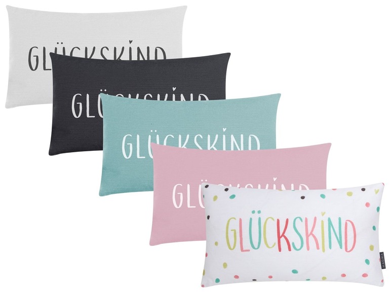 Kussens met de tekst 'Glückskind' in verschillende kleuren en patronen.