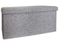 Grijze opbergkist met stoffen bekleding.