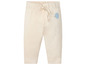Beige babybroek met olifant en ballonprint.