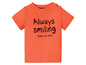 Oranje baby T-shirt met de tekst 'Always smiling (that's not true)'.