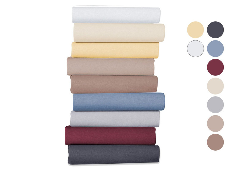 Stapel bedlakens in verschillende kleuren.