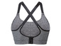 Grijze sportbeha met zwarte bandjes en rits aan de voorkant.