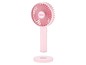 Een roze draagbare ventilator van Unold met oplaadbasis.