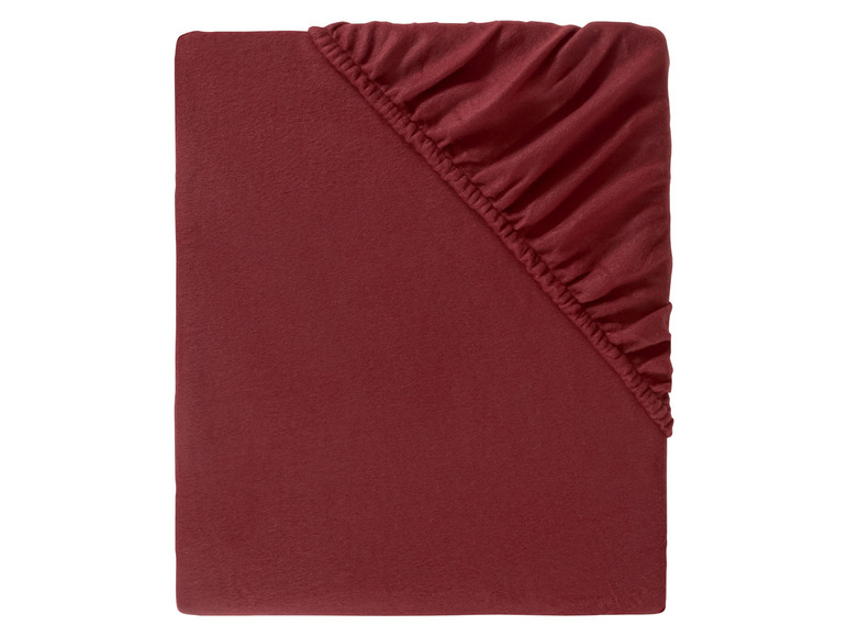 Een donkerrode hoeslaken met elastiek.