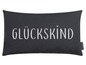 Een donkergrijze kussen met de tekst 'Glückskind' van Magma.