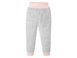 Grijze joggingbroek met roze details.