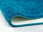 Een turquoise badmat met antislip onderkant.