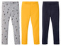 Drie leggings: grijs met figuurtjes, geel en donkerblauw.