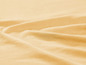 Een zachte, gerimpelde stof in een beige tint.