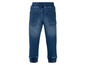 Een paar blauwe jeans met elastiek in de tailleband.