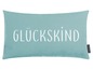Een turquoise kussen met de tekst 'Glückkind'