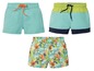 Drie badshorts voor jongens: één effen lichtblauw, één met kleurblokken en één met een jungleprint.