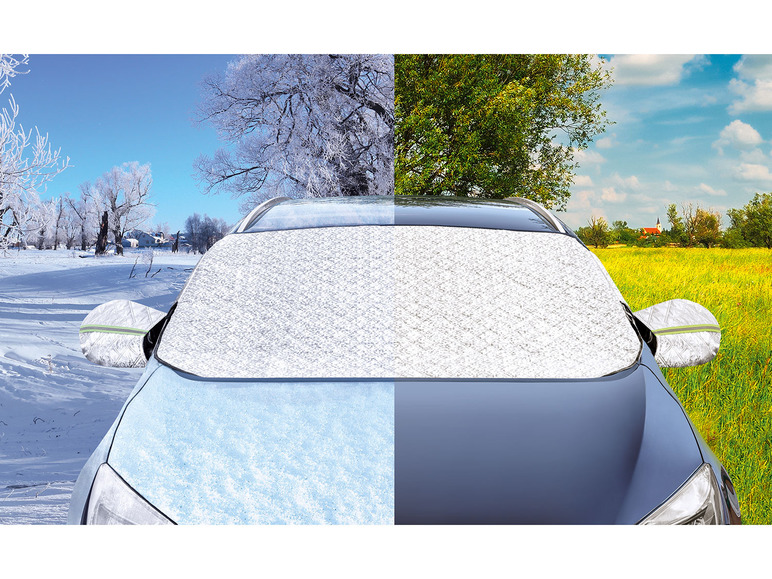 Een auto met een zilveren zonnescherm, winter- en zomerlandschap