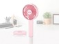 Een roze draagbare ventilator van Unold met een oplaadbare basis.