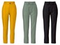 Drie paar damesbroeken in geel, groen en zwart.