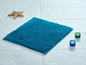 Turkooise badmat met twee kaarsen