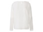 Witte blouse met lange mouwen en stippenpatroon.