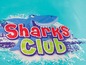 Een blauwe haai springt uit het water met de tekst 'Sharks Club'.