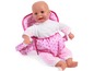 Een roze babypop in een draagzak met witte stippen.