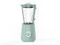 Mintgroene blender met glazen kan en zilveren bedieningsknop op een witte achtergrond