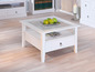 Witte salontafel met glazen blad, lade en plank.