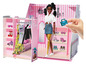 Een roze Barbie Boutique met een pop, kleding en accessoires.