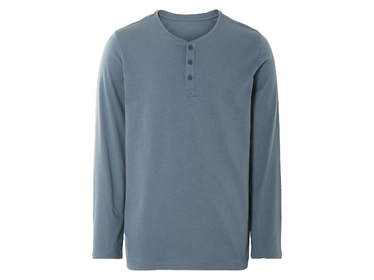 Een lichtblauw longsleeve shirt met knopen