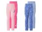 Set van vier kinderleggings: twee roze met alien-thema en twee blauwe met prinsessen-thema.