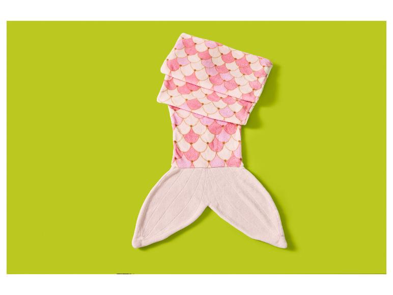 Roze zeemeermindeken met schubbenpatroon op een groene achtergrond.