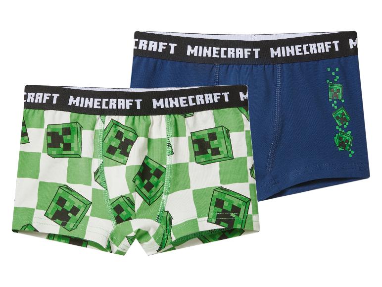 Twee paar jongensboxershorts, één groen-wit geblokt met creepergezichten, de andere blauw met creeperafbeeldingen.