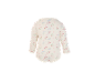 Baby romper met lange mouwen en bloemenprint op crèmekleurige achtergrond.