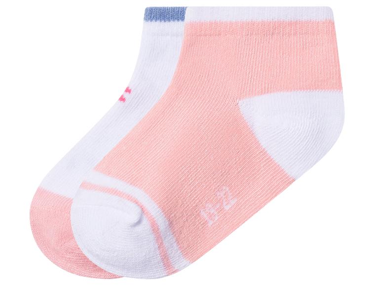 Twee paar korte babysokken, één roze en één wit met blauwe en roze details