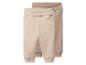 Twee babybroeken in beige en lichtbruine tinten