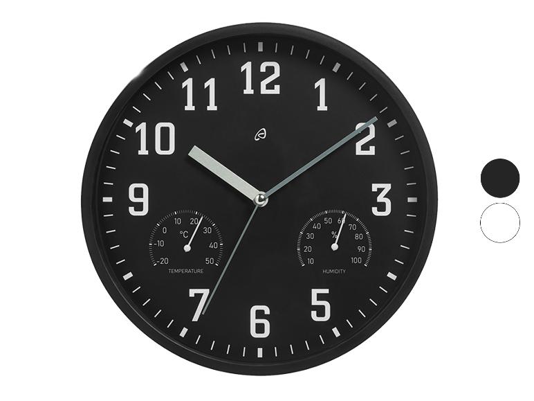 Zwarte wandklok met thermometer en hygrometer.