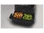 Zwarte Philips airfryer met twee manden gevuld met broccoli en kroketten.