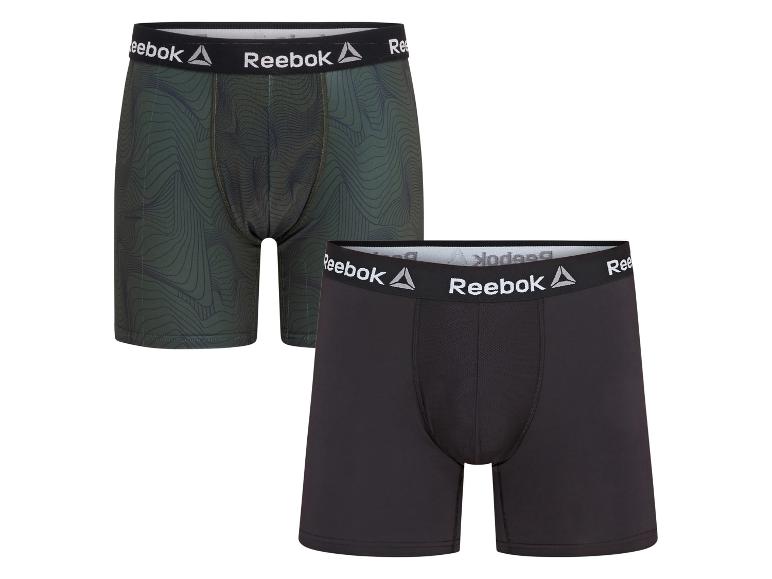 Twee Reebok boxershorts, één groen met patroon en één zwart.