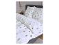 Wit beddengoed met kerstboompatroon in een slaapkamer.