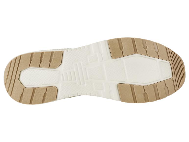 Onderkant van een schoenzool met een beige en witte textuur.