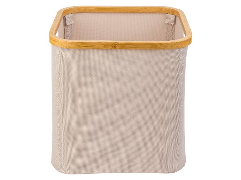 Beige wasmand van stof met bamboe rand.