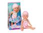 Babypop in roze flamingozwempak en badmuts, in en uit de doos.