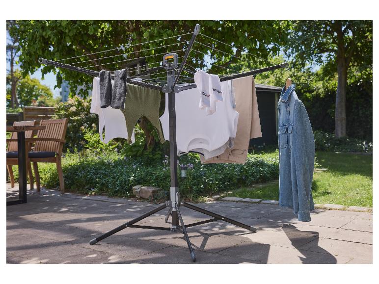 Een opvouwbare waslijn voor buiten met kleding eraan gehangen.