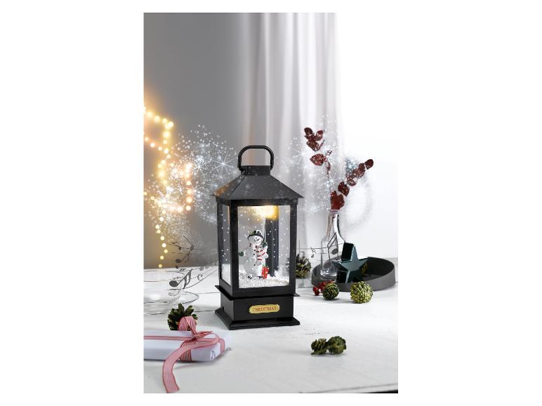 Kerstlantaarn met sneeuwpop, cadeau en feestelijke decoraties.