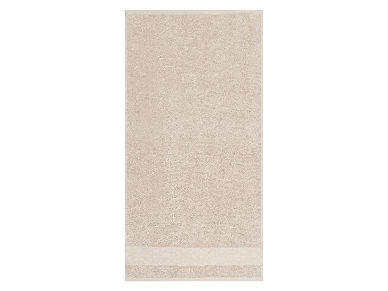 Beige badhanddoek met een subtiele patroonrand